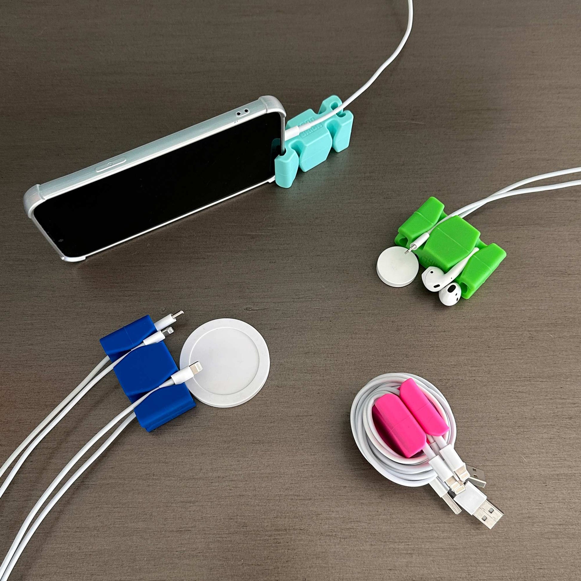 4 Assorted Color CordBricks holding cords, wrapping cords, standing phones and grabbing AirPods