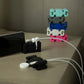 Black CordBricks on a nightstand holding cords and standing phones with other assorted colors