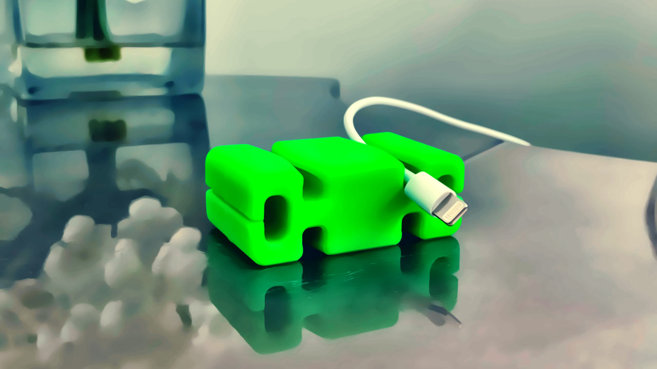 One green CordBrick keeps an Apple iPhone lightning phone charger cable on an end table.