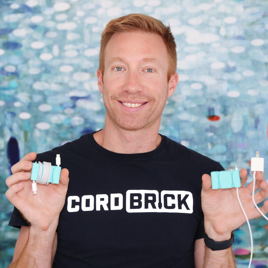 CordBrick Nick - founder of CordBrick - holding up CordBricks