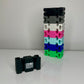 Printed Black promo CordBrick with BUILD Something logo and other CordBrick color options on a white desk