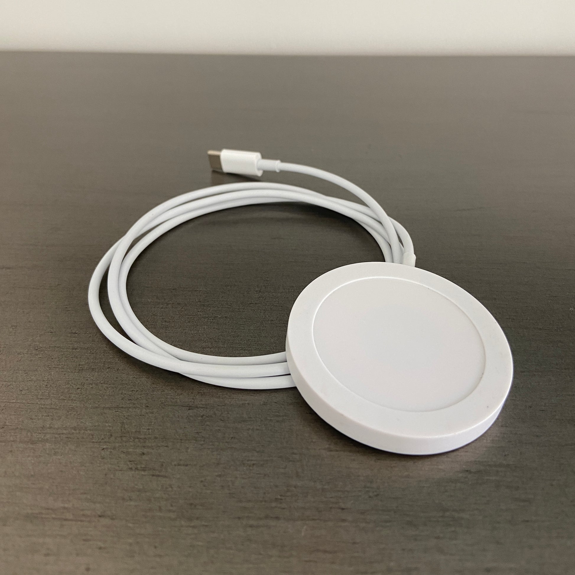 Wireless USB-C Charger Cord white on gray desk