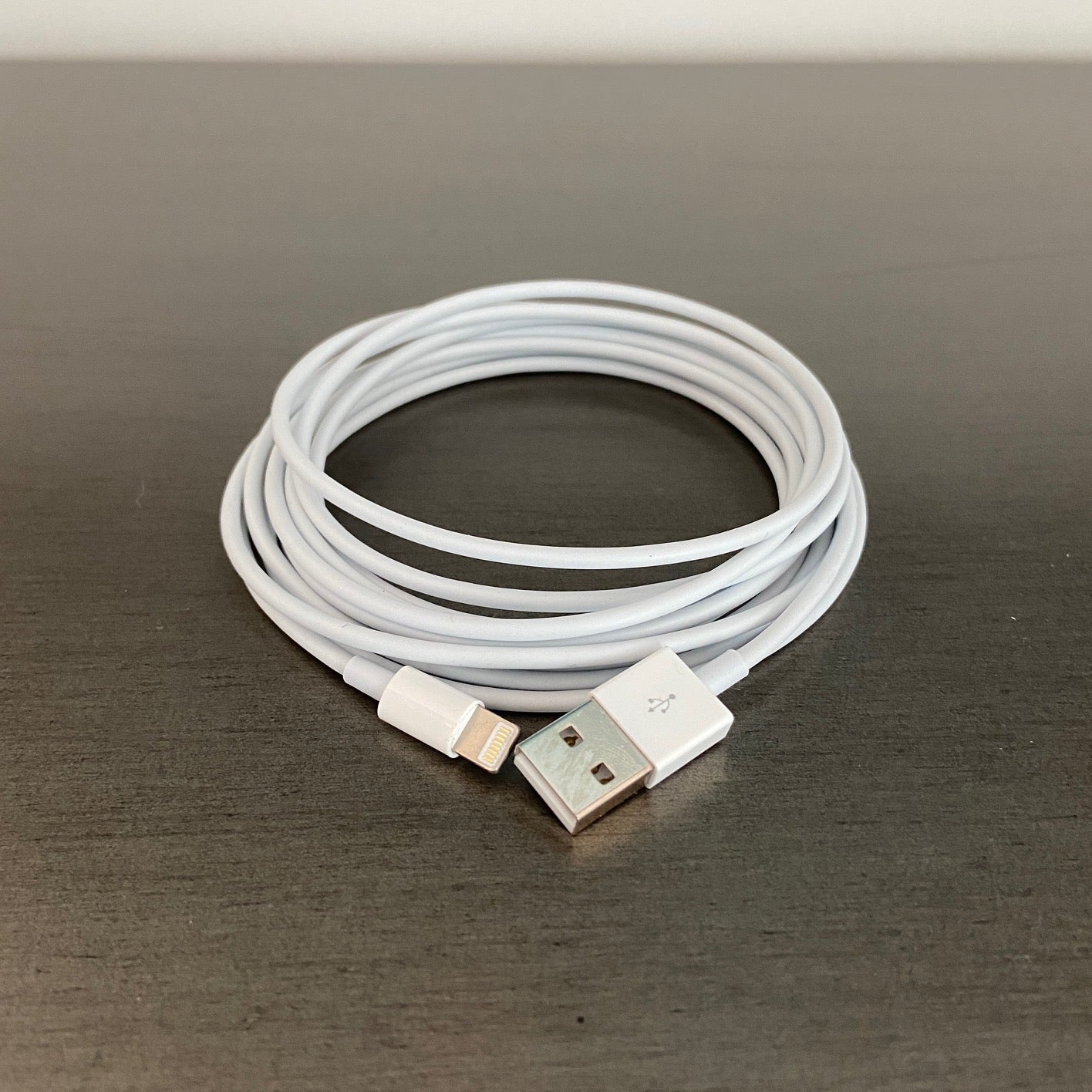 10 foot iPhone charger cord on a gray desktop